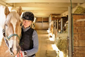 Rider with horse in stable